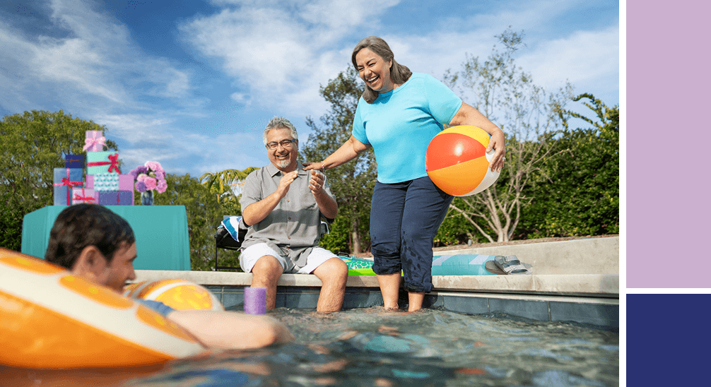 Two men and woman sitting next to the pool.