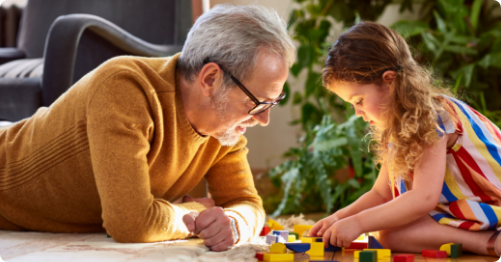 Man and child playing with blocks.