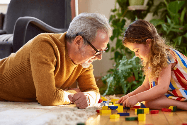 Man and child playing with blocks.