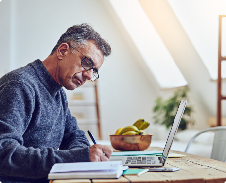 Man writing at desk.