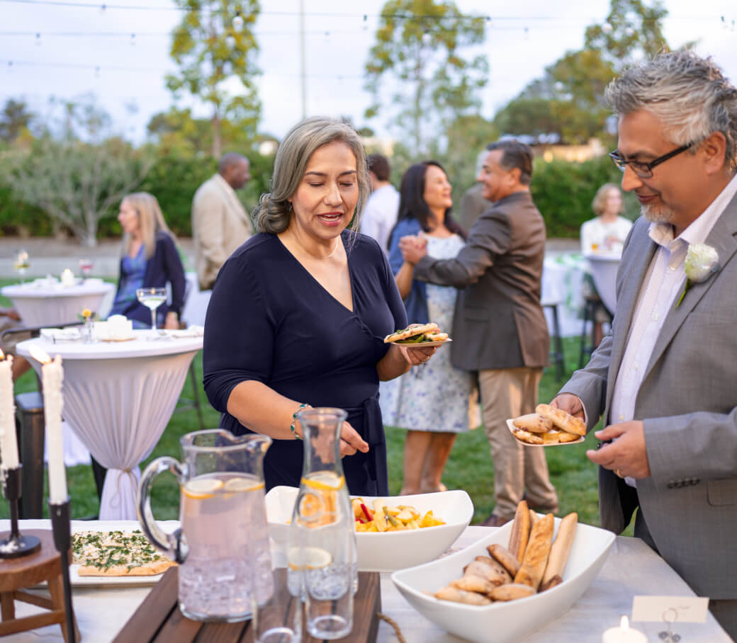 Man and woman talking next to a table.