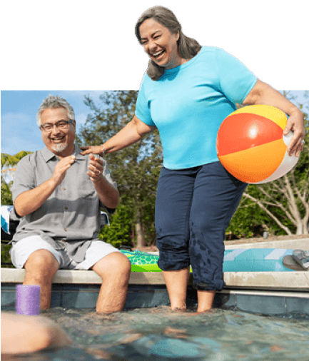 Two men and woman sitting next to the pool.
