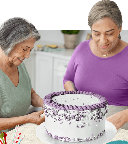 Two women baking a cake.