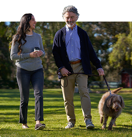 Man and woman walking dog.