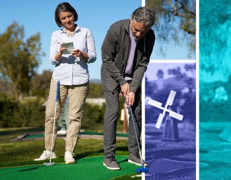 Man and woman playing putt putt golf.